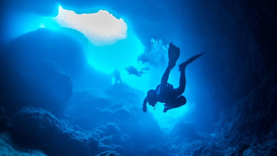 scuba diver swimming upwards